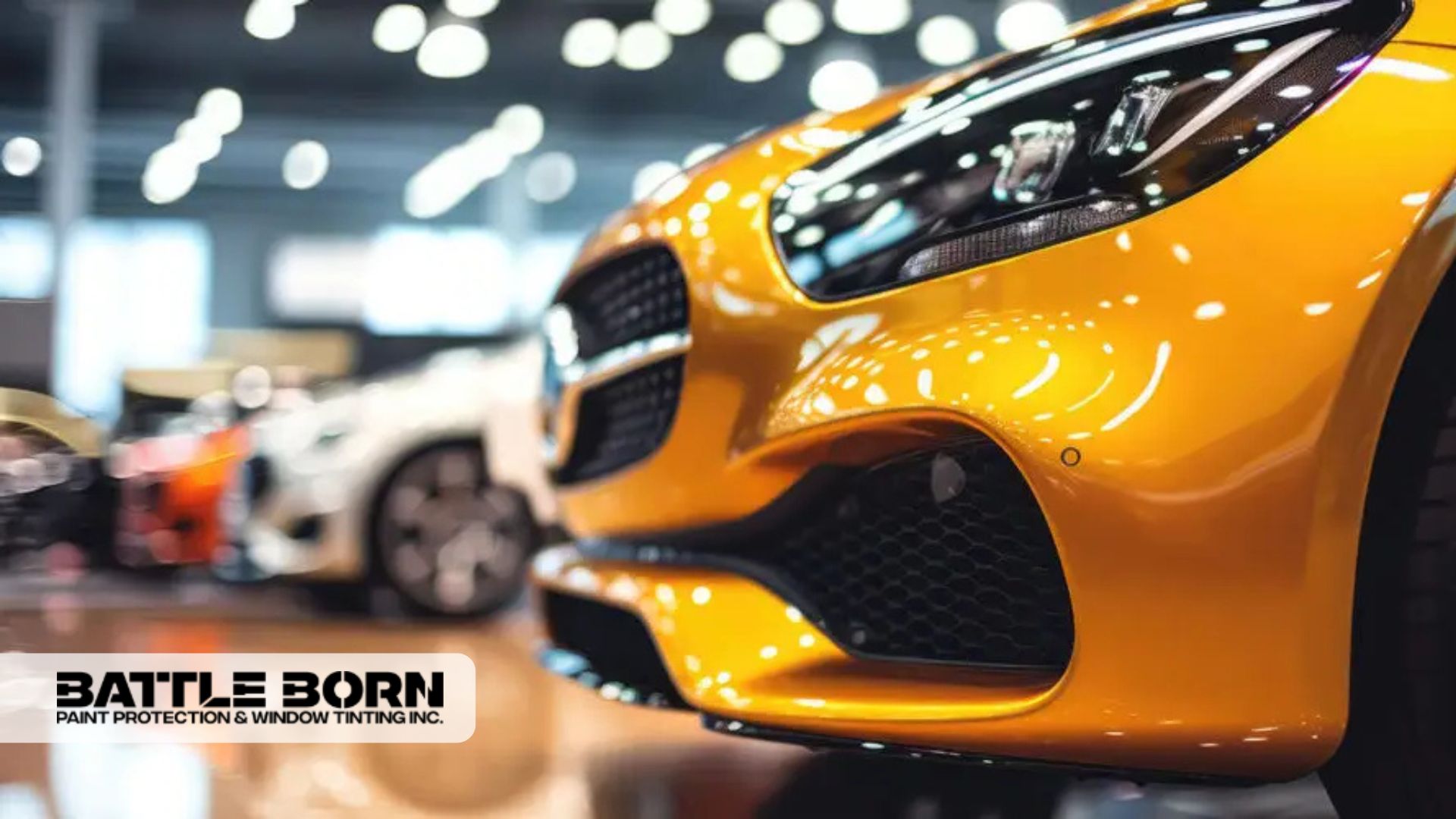 Close-up of a glossy yellow luxury car with a mirror-like finish on display in a well-lit showroom.